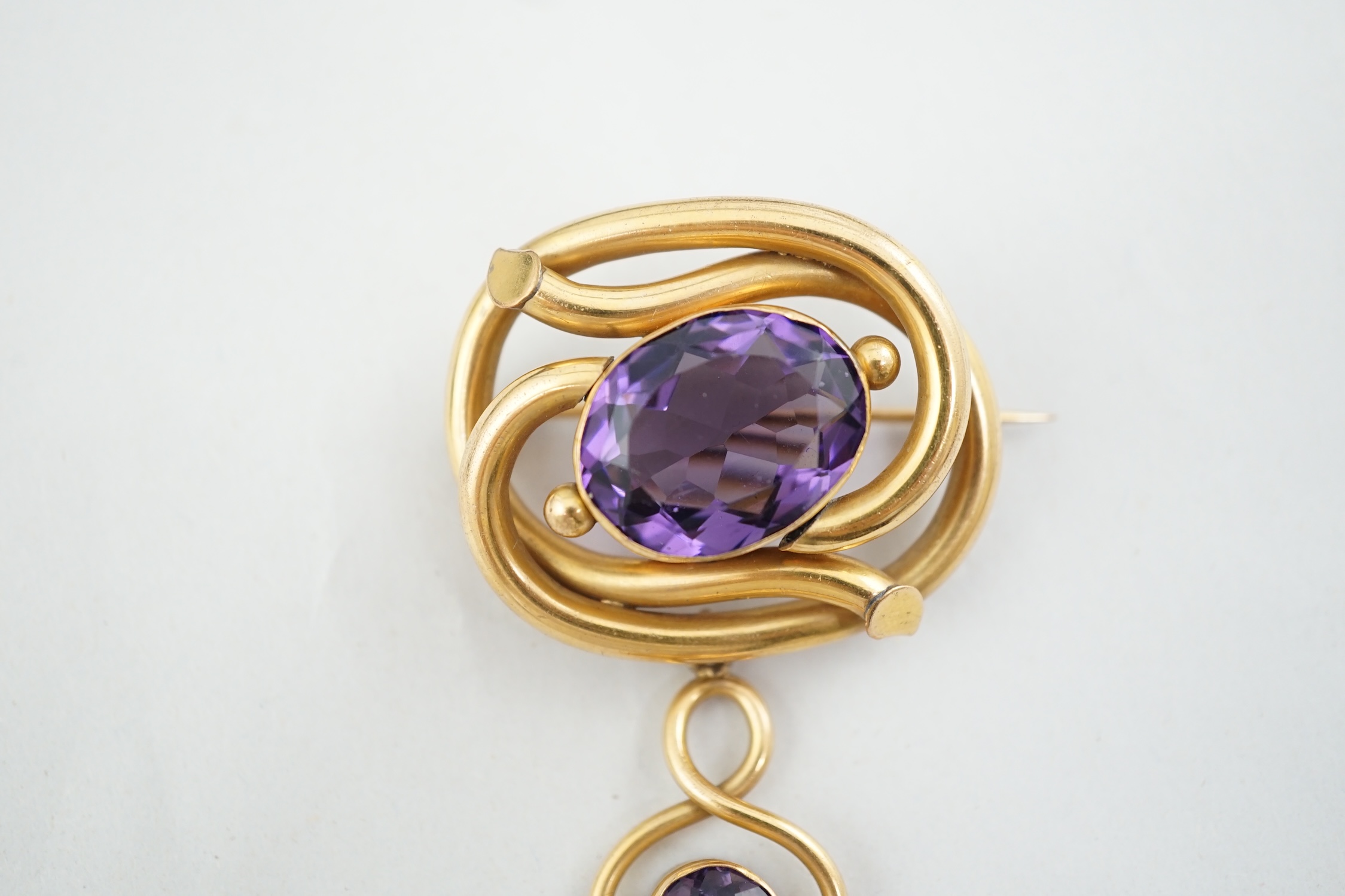 A Victorian gilt metal and two stone amethyst set drop brooch